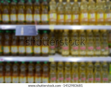 abstract blurred of cooking oil bottles on shelf for sale at supermarket.