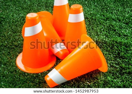 Soccer tactics on grass field with cone for training