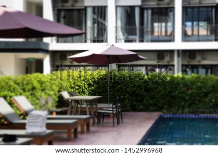 Bench at swimming pool in the hotel, stock photo