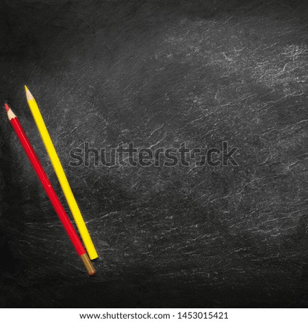 Back to school concept. Education background with copyspace and colourful pencils on Black old empty chalkboard.  Flat lay 


