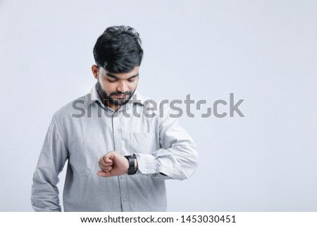 Young indian man watching time in wrist Watch
