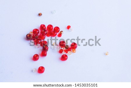 close up of red and white beads isolated on white background.