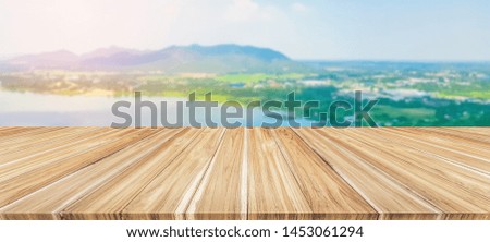 Brown wooden table,beautiful wood texture and pattern,background tropical natural landscape,mountain and sky,web banner horizontal panoramic,display montage for product,mock up for show,copy space