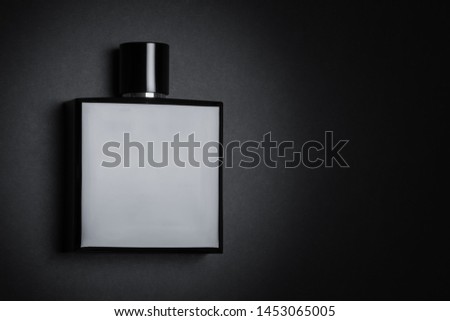Fragrance perfume bottle mockup on dark or black empty background. Top view. Horizontal photo with copy space  