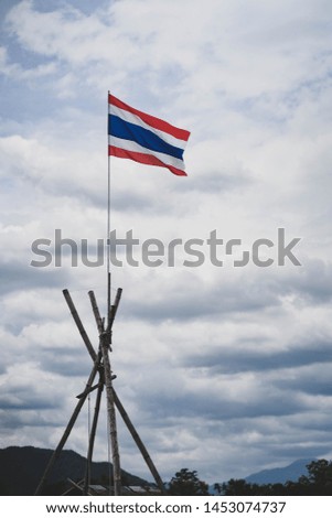 Colorful  national THAI flags With cloudy sky as background.