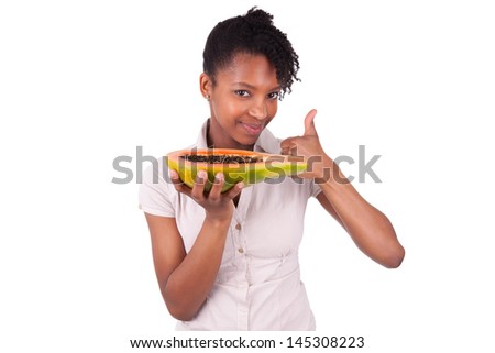 Young happy black / african american woman holding fresh papaya isolated on white background