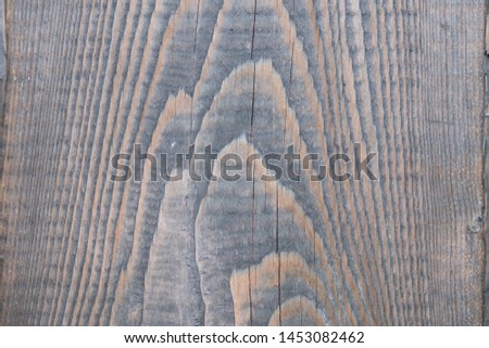 Background from old wood texture. Softwood boards. Annual rings and cuts from branches (knots) Beautiful, natural pattern. Summer, sunny day.