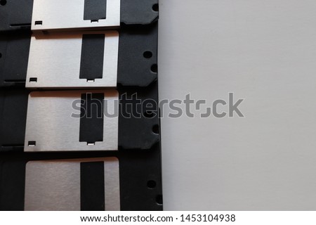 close-up picture of some black floppy disk on white background