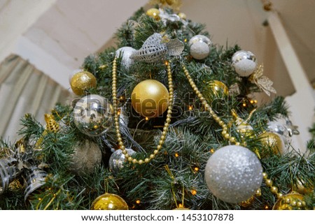 Christmas tree branch decorated with beautiful shiny balls before New Year
