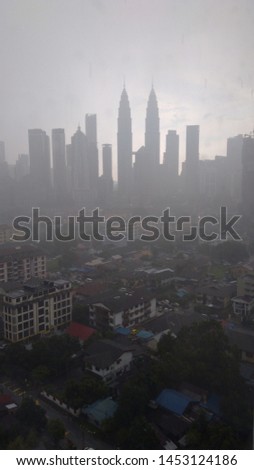 view image of kuala lumpur cityscape during heavy rain