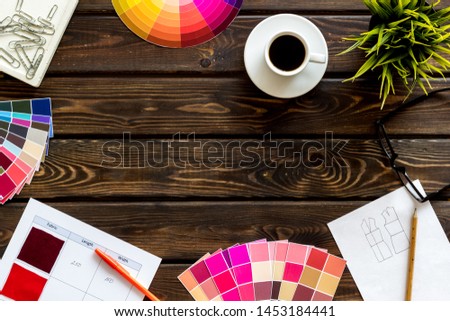 Designer office desk with tools, pallet, coffee and glasses on wooden background top view mock up