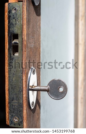 A key for lock or unlock wooden door texture, Close up & Macro shot, Selective focus, Security concept