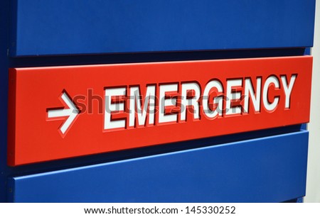 A blue and red Emergency sign outside a hospital