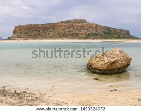 Amazing Balos blue Lagoon with Cape Tigani in the center in Crete island, Greece. Viewpoint from the Balo's beach of Kissamos Bay. Wonderful beauty wild coast with sandy shore and shallow sea water. Royalty-Free Stock Photo #1453324052