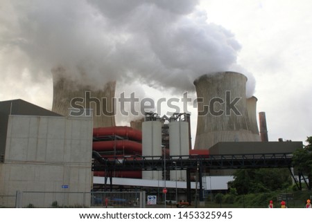 Coal-fired power plant with smoking chimneys