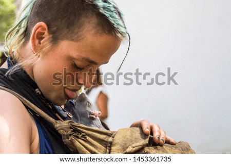 LifeStyle Photography. Punk Girl portrait kissing a mouse