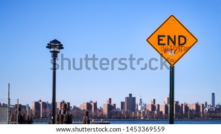 Williamsburg, Brooklyn, New York, United States of America - END road sign against a backdrop of Manhattan skyline across the East River.
