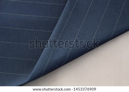 blue striped fabric, fold of fabric close-up
