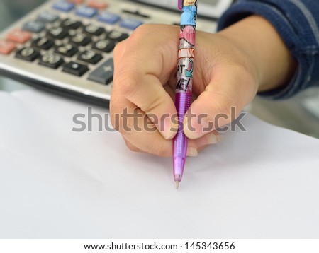 Businesswoman makes a note in notebook
