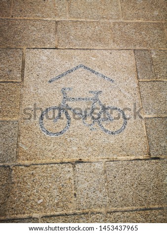 A cycle lane sign embedded in the floor showing where the cyclists route goes