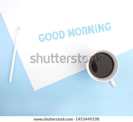 
Writing text captions, showing good morning. Business concept for new day or week. Motivation written.
on white paper on a blue background with a pencil and coffee