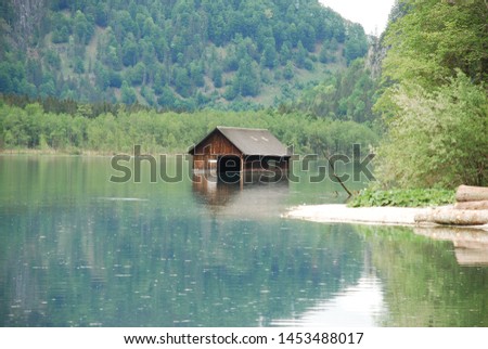 Almost sunken boatshouse on lake Almsee in Upper Austria Royalty-Free Stock Photo #1453488017