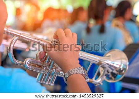 abstact the girl hand pressed the trumpet wedge in the wind instrument