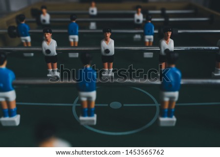 the player of defense versus player Striker a concept business offenses with soccer table