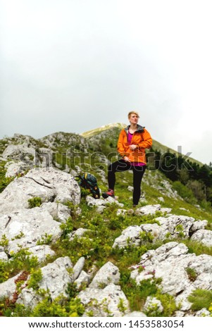 Female hiker hiking on a cloudy day 