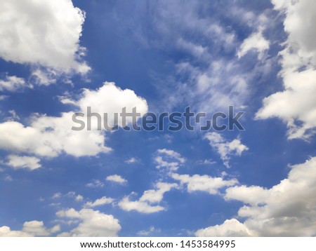 Many white clouds have a blue sky background.