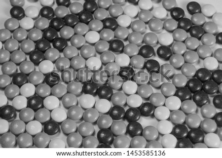 Black and white image of a group of candy pieces