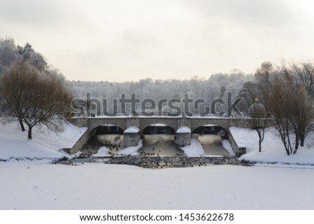 Winter bridge with water reflection of the sun. tsaritsyno