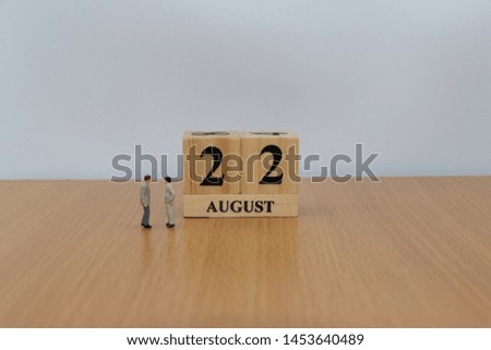 August  22, a calendar photo from the wood The table top consists of a book and pen that is ready to use. White background