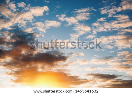 beautiful Sunny summer bright sunset on the horizon with big clouds