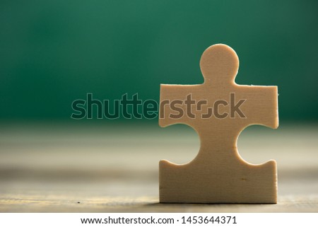 Creative solution for idea - business concept, jigsaw puzzle on the green blackboard background