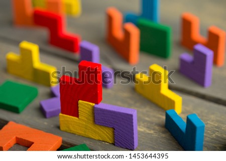 Creative solution for idea - business concept, jigsaw puzzle on the wooden background Royalty-Free Stock Photo #1453644395