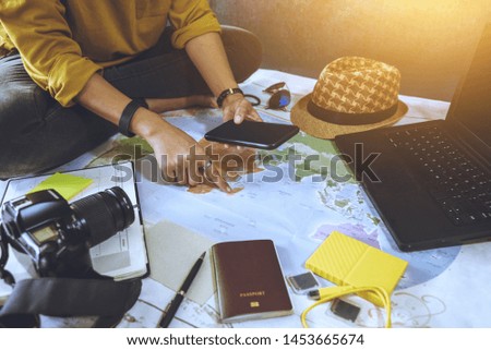 Vacation travel planning concept with map. Overhead view of equipment for travelers. Travel concept background, Young woman pointing to the map. Travel holiday, summer.