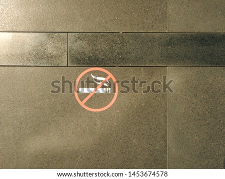 
Sign - do not smoke, depicted on the granite wall.					