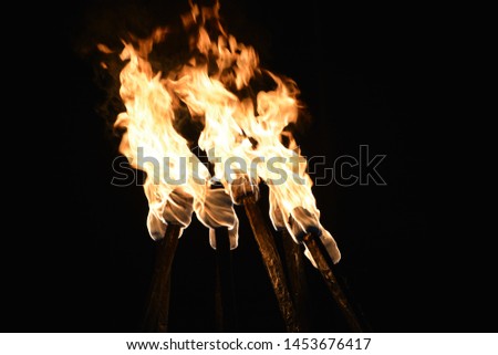 Four flaming torches in the night