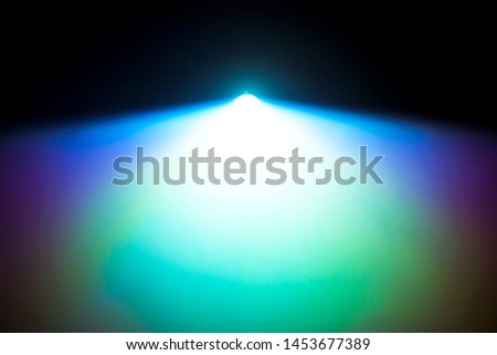 light beam projector in dark black room , smoke abstract background with copy space for text .