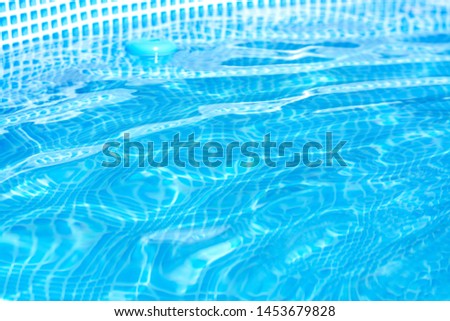 background of bright blue clear water in the pool