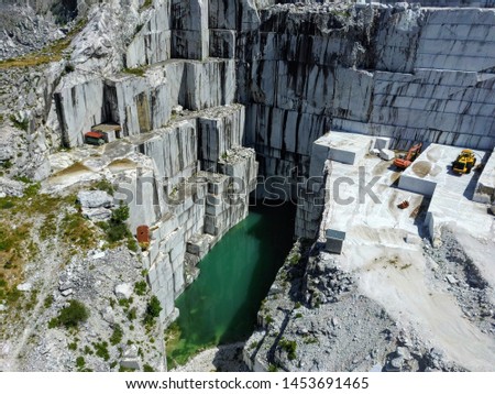 Aerial view of a marble quarry with a pond