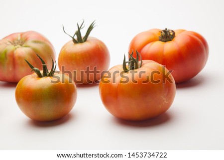 Organic tomato freshly picked from the garden and taken to the market to be sold to the final consumer. From the garden to the table. The tomato can be eaten raw in a salad and we can make juice. You 