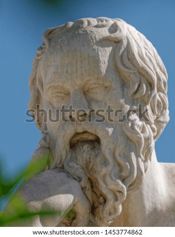 Socrates the ancient Greek philosopher marble statue face detail between foliage, Athens Greece