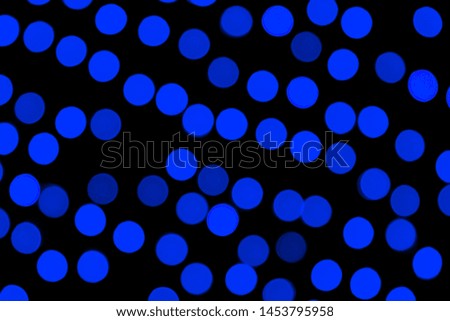 Unfocused abstract dark blue bokeh on black background. defocused and blurred many round light.