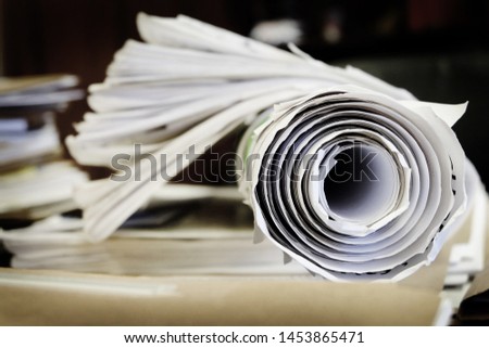Roll of paper in office on desk drafts or blueprints