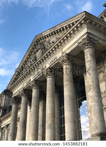 The front of the German parliament, the Bundestag, formerly the Reichstag, bearing the words “Dem Deutschen Volke”, or “The German People”. Royalty-Free Stock Photo #1453882181