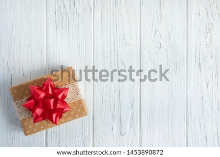 Background with a gift box. Box with a presents boxes on a wooden background. Frame for greeting card. Gift certificate