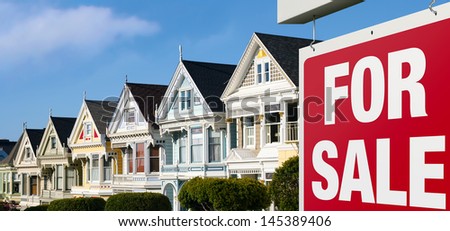 Dreaming of buying one of those colorful iconic San Francisco row houses. For Sale sign is visible in front.