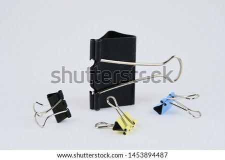 office paper clips of different sizes and colors on white background